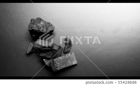 Black color wooden charcoals on dark background 55428686