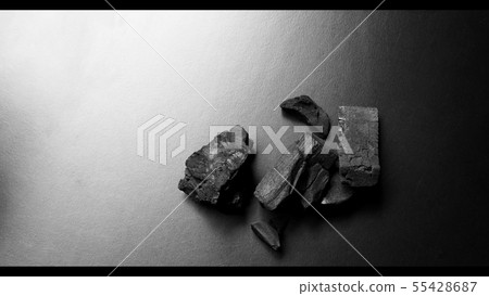 Black color wooden charcoals on dark background Black color wooden charcoals on dark background 55428687