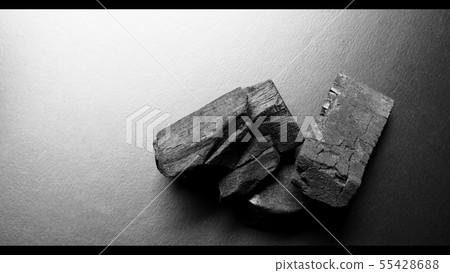 Black color wooden charcoals on dark background Black color wooden charcoals on dark background 55428688