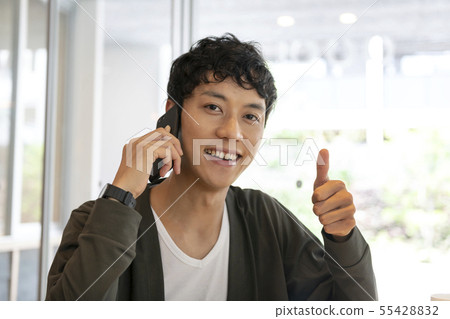 A man who "likes" while talking on a smartphone 55428832