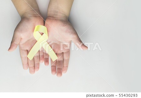 child holding gold ribbon. Cancer awareness child holding gold ribbon. Cancer awareness 55430293