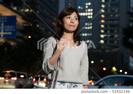 Business woman after work overtime at night Marunouchi Tokyo Urban Japanese female 55432146