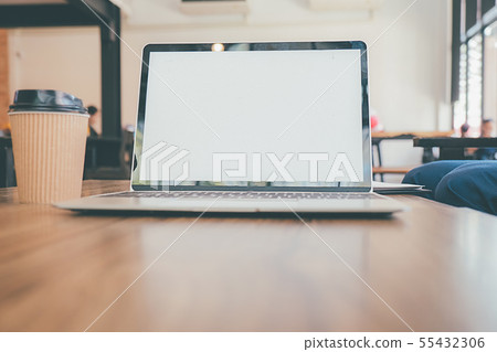 A laptop is placed on table with blank screen 55432306
