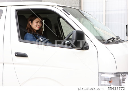 Young woman riding a commercial vehicle Young woman riding a commercial vehicle 55432772