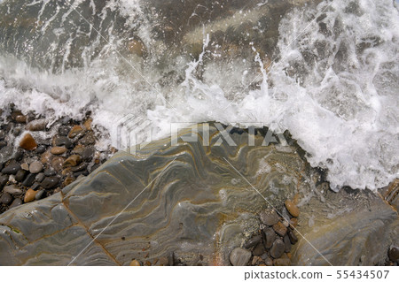 The wave rolls on a rocky shore, aerial view The wave rolls on a rocky shore, aerial view 55434507