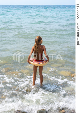 Girl with a circle goes swimming in the sea Girl with a circle goes swimming in the sea 55434511