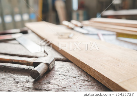 Equipment on wooden desk with man working in 55435727