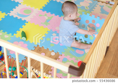 Baby playing in a baby circle Baby playing in a baby circle 55436086