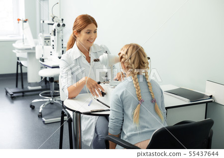 Blonde-haired teenage girl visiting private eye clinic 55437644