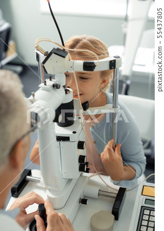 Beautiful girl visiting ophthalmologist at the weekend Beautiful girl visiting ophthalmologist at the weekend 55437805
