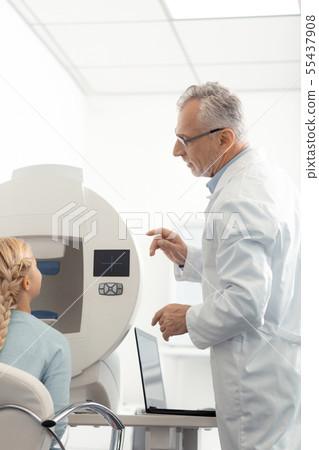 Eye specialist speaking to girl telling her some advice Eye specialist speaking to girl telling her some advice 55437908