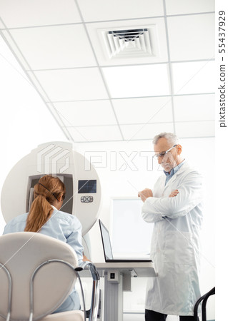 Eye specialist waiting for the result of electronic monitoring 55437929