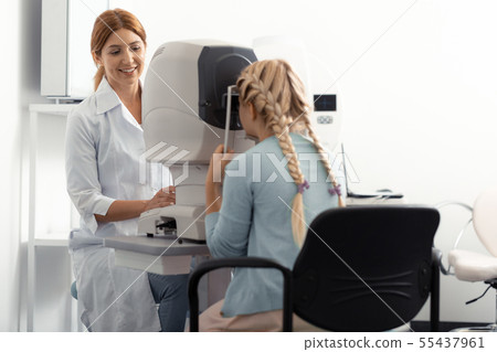 Long-haired teenage girl visiting ophthalmologist after school Long-haired teenage girl visiting ophthalmologist after school 55437961