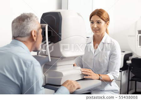Grey-haired retired man having eye doctor consultation Grey-haired retired man having eye doctor consultation 55438008