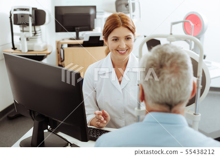 Top view of professional eye specialist speaking to patient 55438212