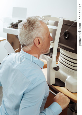 Man sitting straight while having eye sigh analysis 55438257