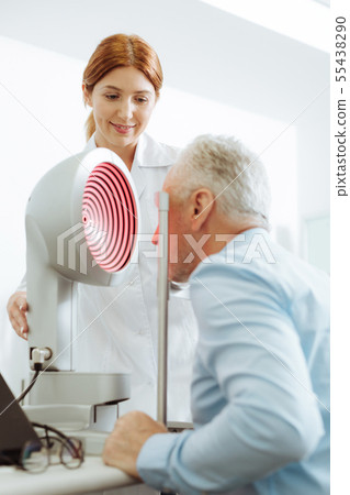 Grey-haired aged man visiting eye specialist every year Grey-haired aged man visiting eye specialist every year 55438290
