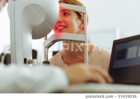 Woman sitting in front of eye doctor while coming for consultation 55439036