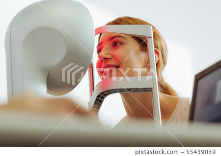 Beautiful woman smiling while having eye examination 55439039