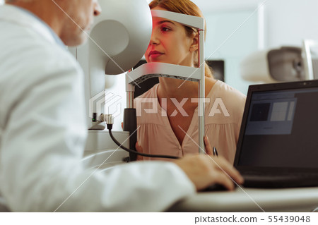 Woman wearing stylish blouse having consultation of eye doctor 55439048