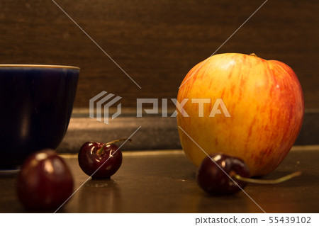 Background big apple and three cherries on the 55439102