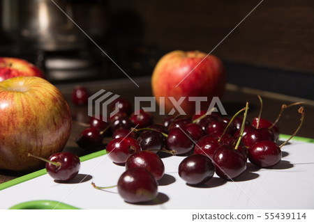 Background apples and cherries on the blackboard. 55439114