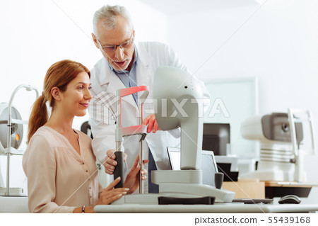 Eye specialist using modern technology during consultation 55439168
