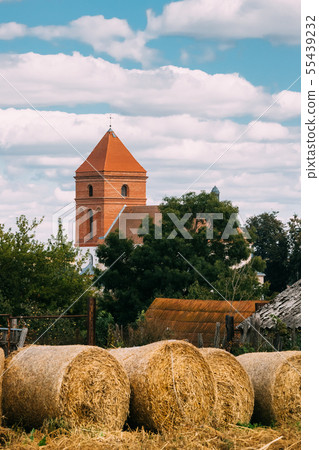 Mir, Belarus. Autumn Hay Bales And Saint Nicolas Roman Catholic Church On Background. Mir, Belarus 55439232