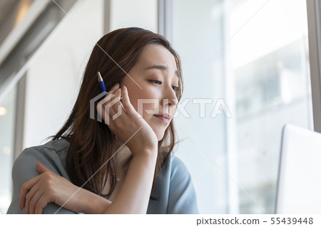 Thinking woman with a cane 55439448