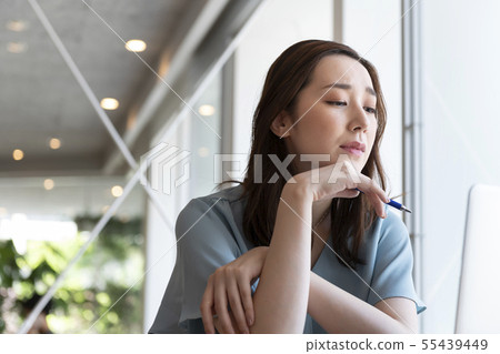 Thinking woman while looking at the computer screen 55439449
