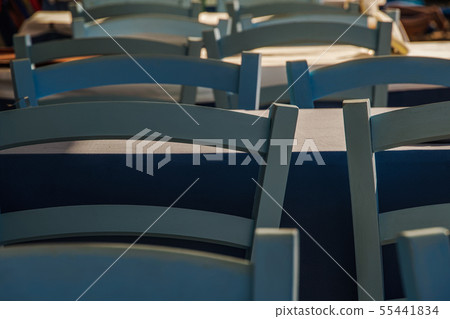 Tavern concept row of empty chairs detail. 55441834