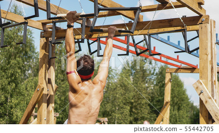 Man passing through hurdles during obstacle course in boot camp Man passing through hurdles during obstacle course in boot camp 55442705