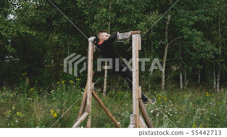 Man passing through hurdles during obstacle course in boot camp Man passing through hurdles during obstacle course in boot camp 55442713