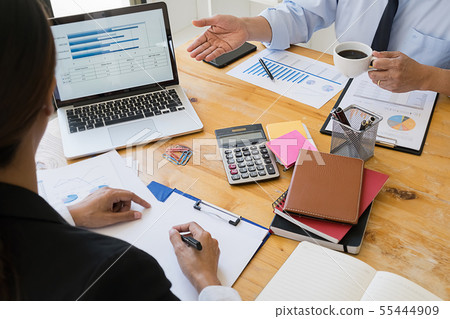Business adviser analyzing financial figures Business adviser analyzing financial figures 55444909
