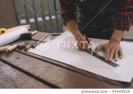 Carpenter working with equipment on wooden table Carpenter working with equipment on wooden table 55444929