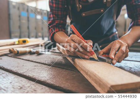 Carpenter working with equipment on wooden table Carpenter working with equipment on wooden table 55444930