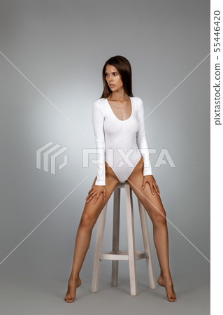 beautiful perfect woman in white bodysuit 55446420