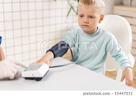 Doctor measuring blood pressure of a little boy. Diagnostic, healthcare, medical service. Doctor 55447072