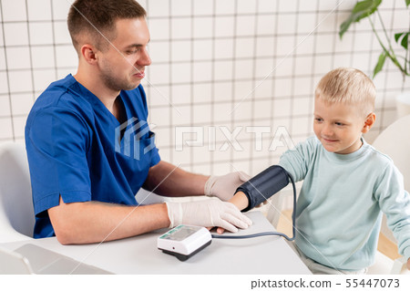 Doctor measuring blood pressure of a little boy. Diagnostic, healthcare, medical service. Doctor 55447073