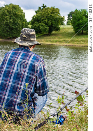 Fisherman fishes on the lake Fisherman fishes on the lake 55448218