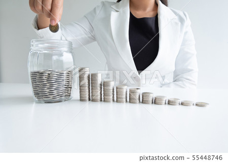woman hand putting coin into glass bottle bank woman hand putting coin into glass bottle bank 55448746