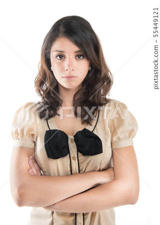 A young woman looks at the camera in annoyance and arms folded. A young woman looks at the camera in annoyance and arms folded. 55449121