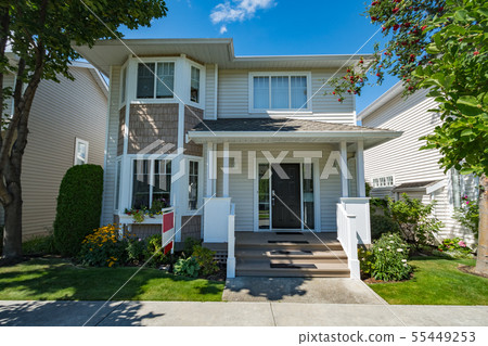 Residential house with concrete pathway in front Residential house with concrete pathway in front 55449253