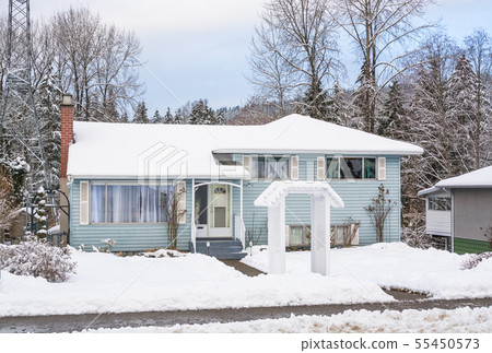 Average North American house in snow on winter cloudy day Average North American house in snow on winter cloudy day 55450573