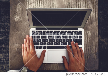 Top view of modern laptop with male hands on it 55451345