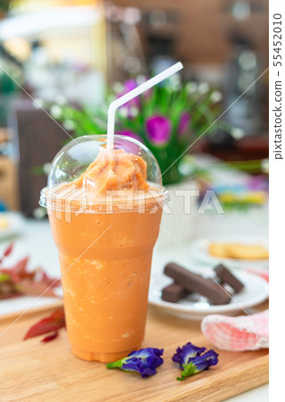 Milk tea or Thai milk tea on the wooden plate. 55452010