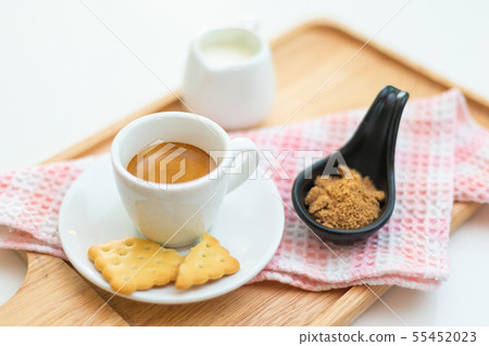 Coffee americano and saucer on a wooden plate with 55452023