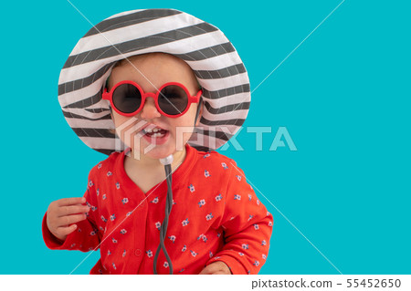 Child in sunglasses and hat 55452650