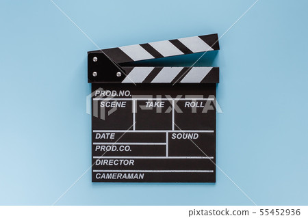Movie clapper board on blue background Movie clapper board on blue background 55452936