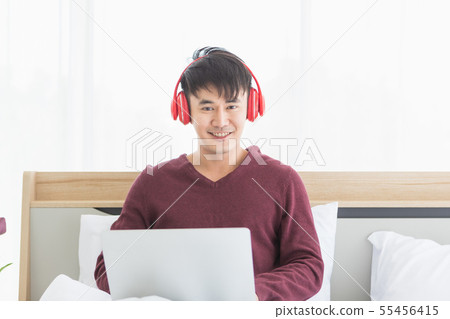 Asian man listen to music by headphone in Asian man listen to music by headphone in 55456415